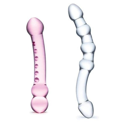 Pink and clear glass massage tools on a white background