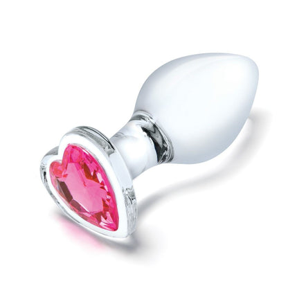 Clear anal plug with a pink heart-shaped gem on a white background