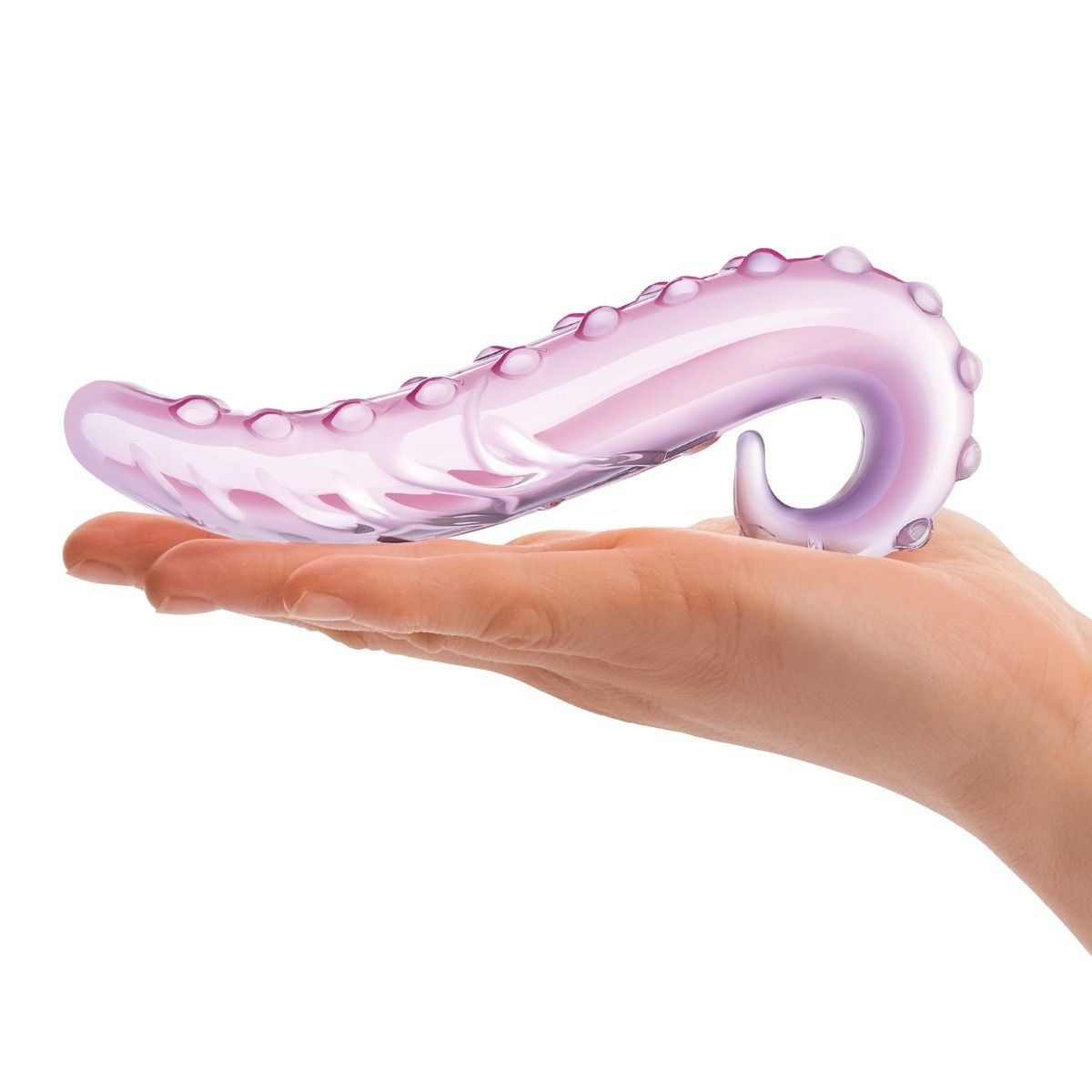 Pink octopus-shaped object held in a hand on a white background