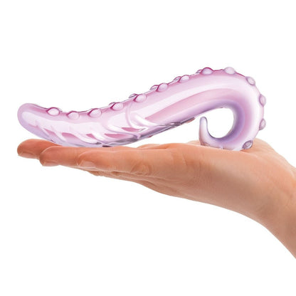Pink octopus-shaped object held in a hand on a white background