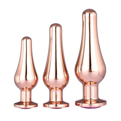 Three rose gold butt plugs of different sizes on a white background