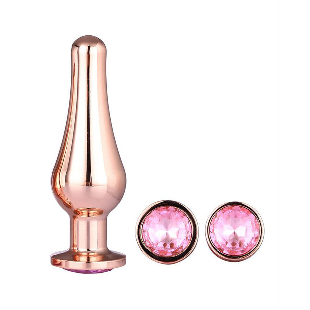 Rose gold plug with pink gemstones on a white background