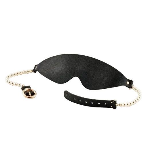 Black eye mask with gold chain on a white background
