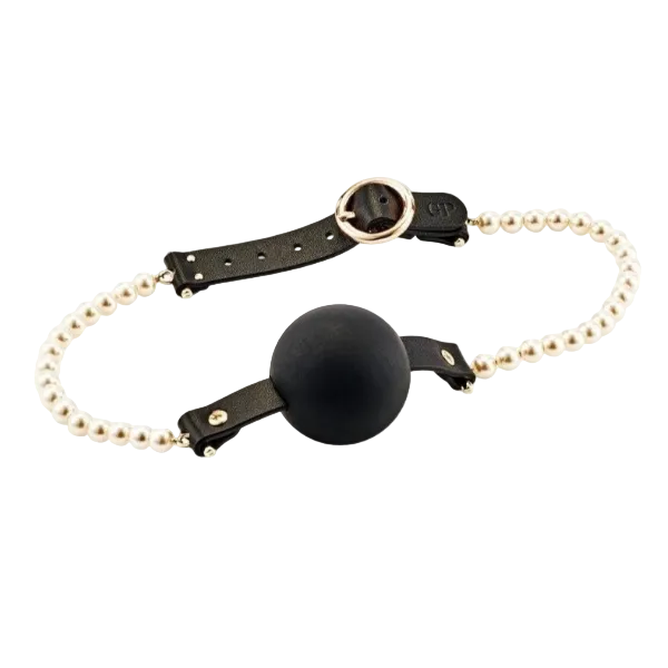 Black ball gag with gold and pearl chain on a white background