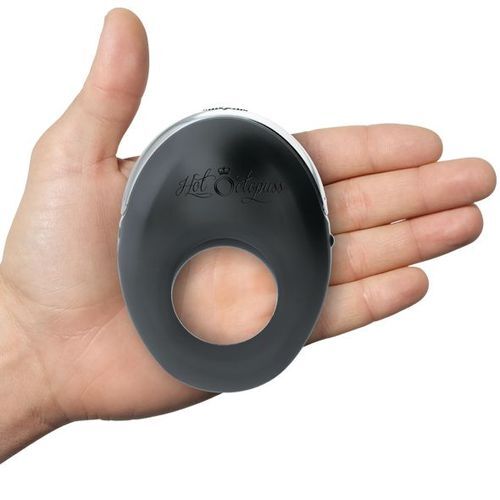 Hand holding a black silicone cock ring with 'Hot Octopus' branding on a white background