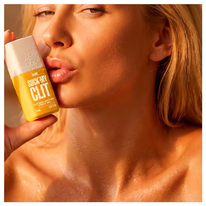 Woman holding a product labeled 'Suck My Clit' with a close-up focus.