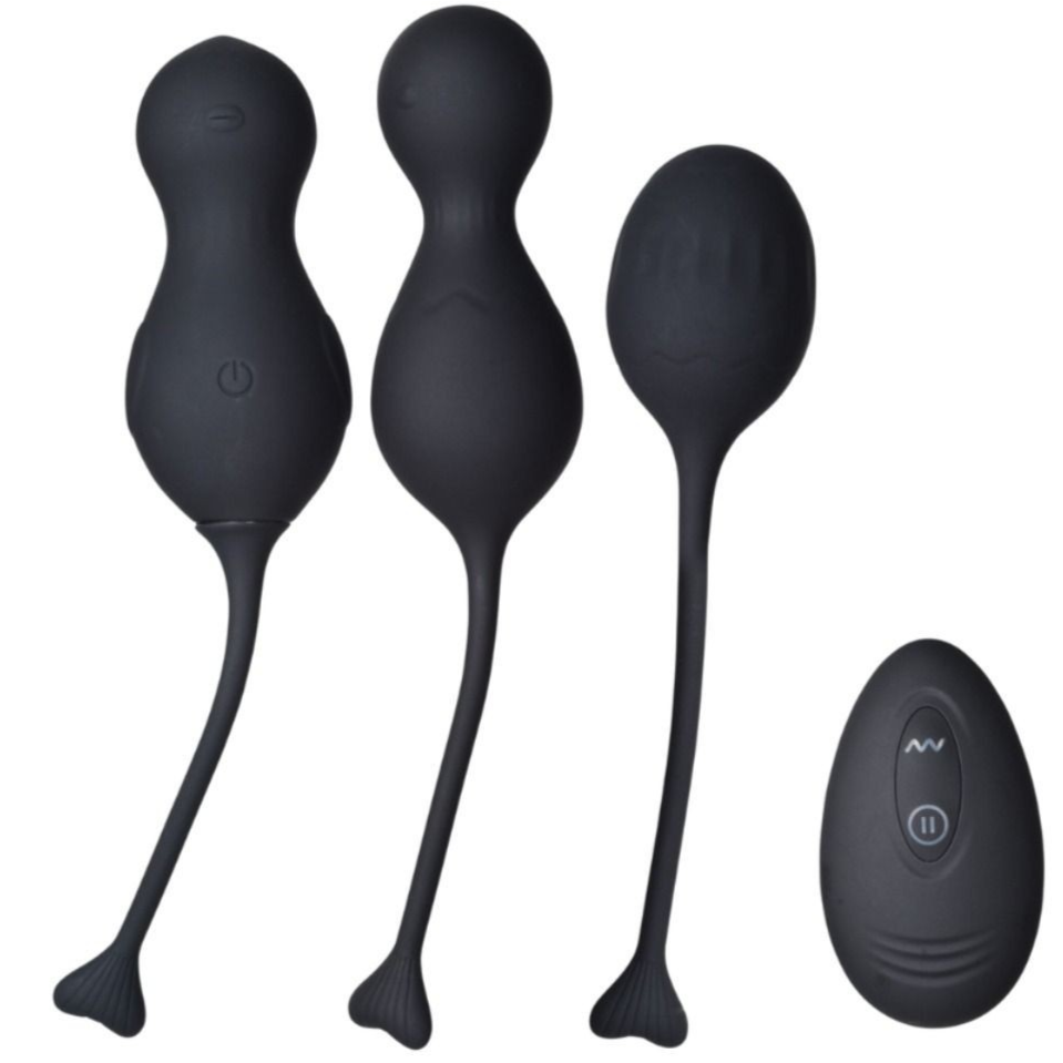 Set of black massage tools with remote control on a white background