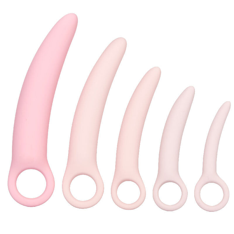 Set of five pink silicone tools with handles on a white background