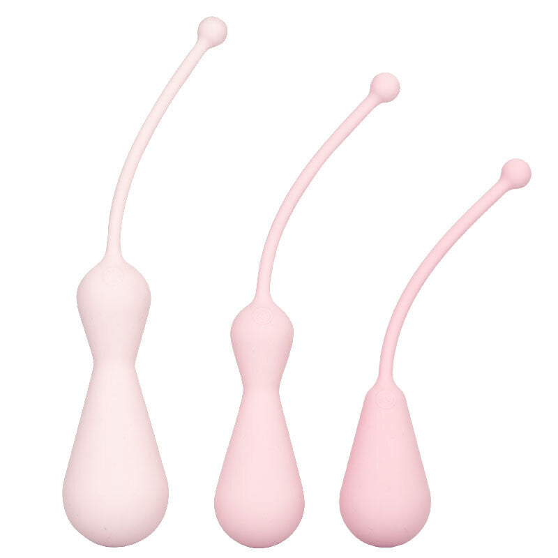 Three pink silicone tools with flexible stems on a white background