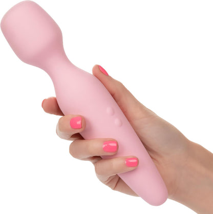 Pink handheld massager held by a hand with pink nail polish on a white background