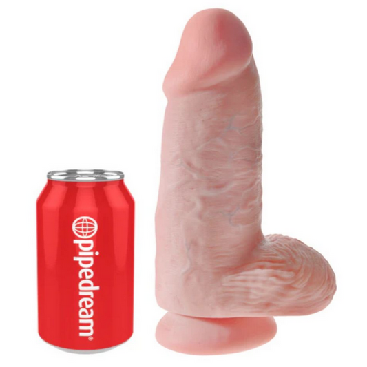 Pink novelty product shaped like a penis next to a red can with 'pipedream' branding on a white background