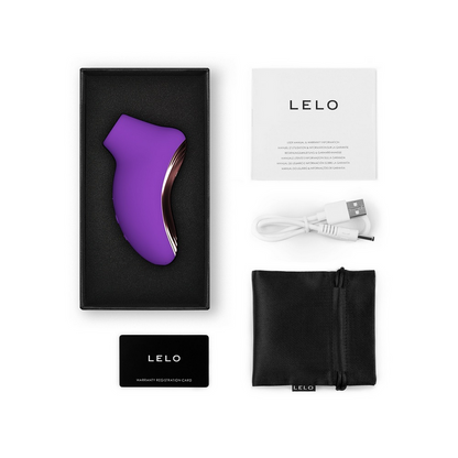 Purple electronic device with packaging, USB cable, and black pouch on a white background