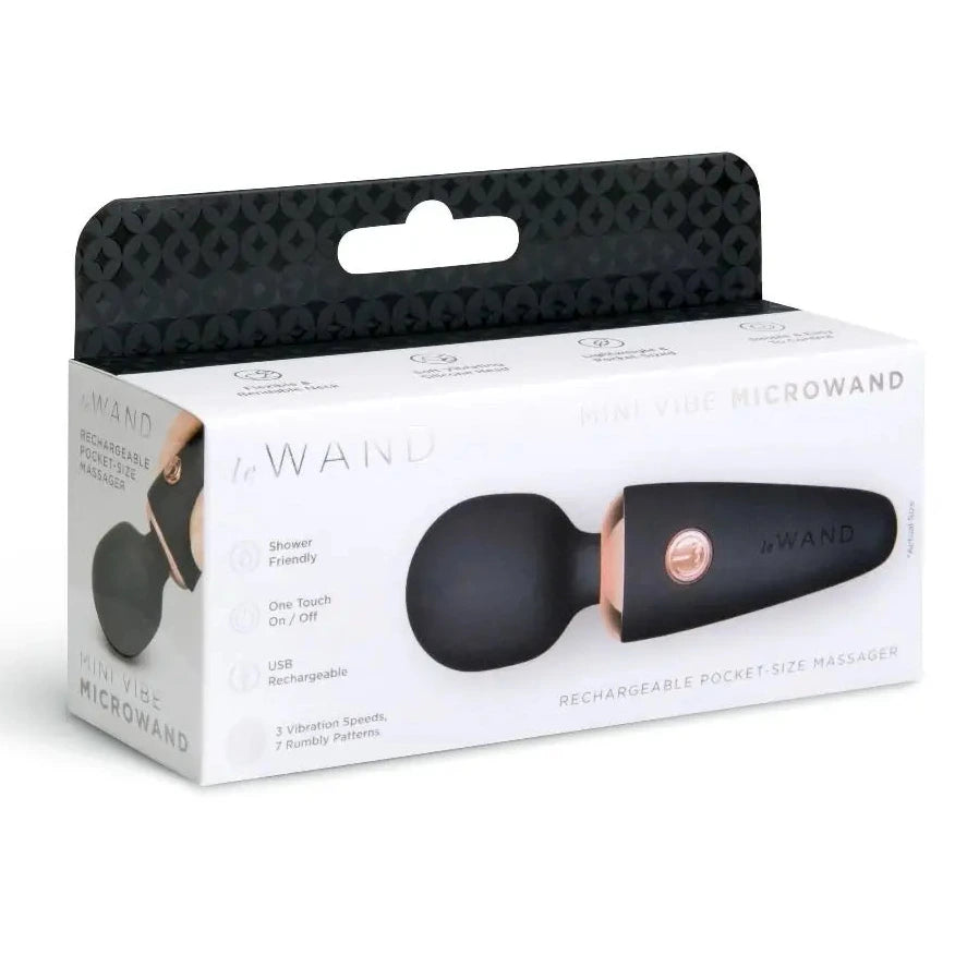 Aboxed black and rose gold microwand on a white background