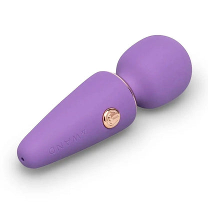 Purple electronic massager device with a rose gold button on a white background