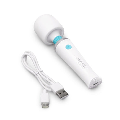 White handheld device with USB cable on a white background
