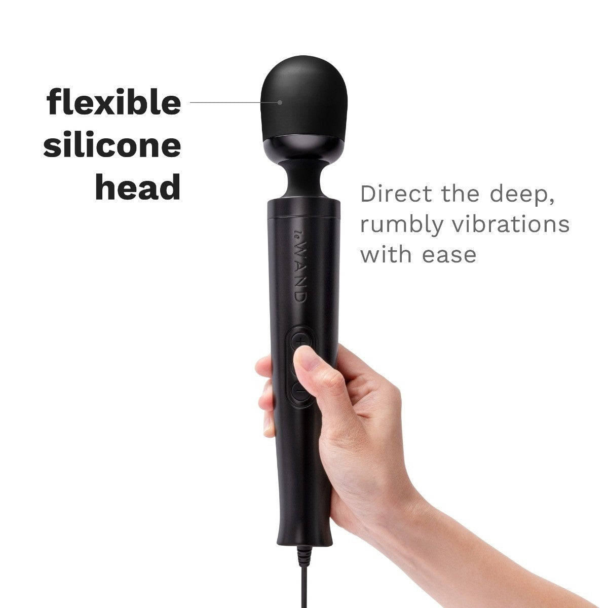 Black handheld massager with flexible silicone head held by a hand on a white background