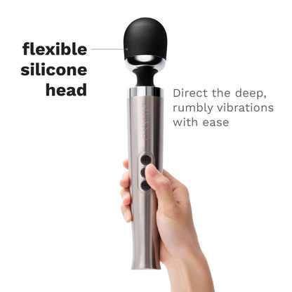 Hand holding a handheld massager with a flexible silicone head on a white background