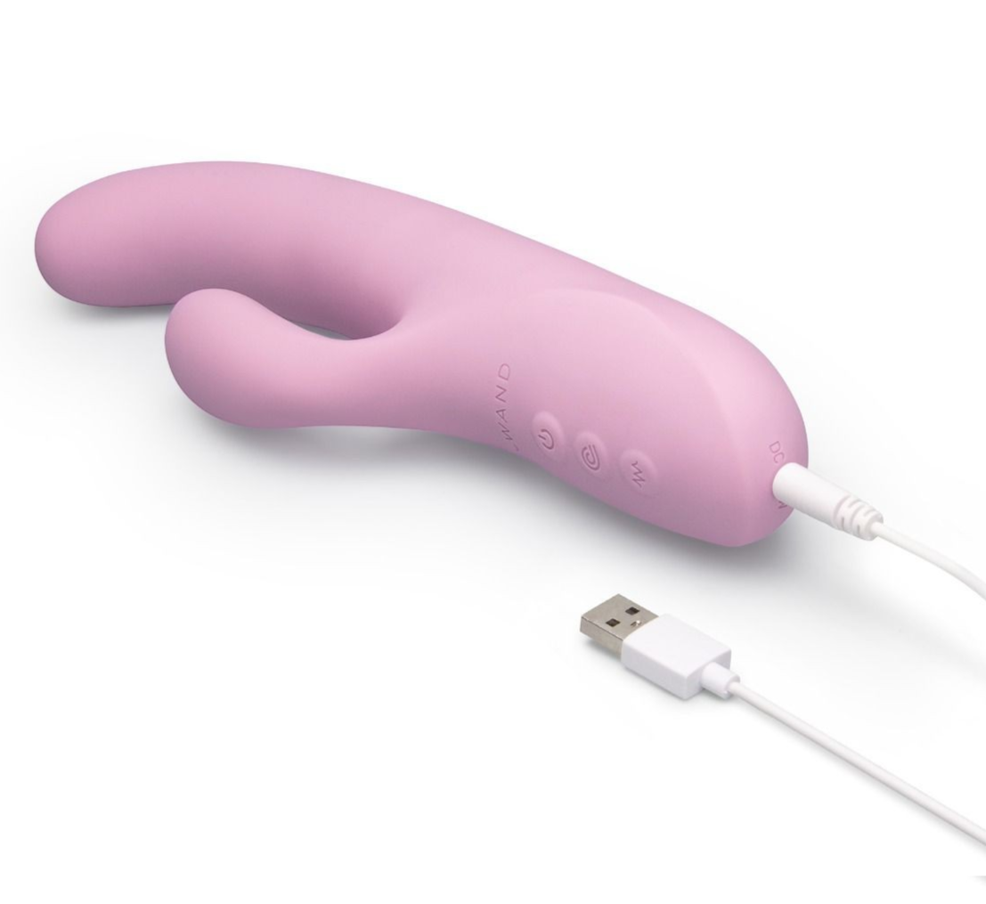 Pink electronic device with USB cable on a white background