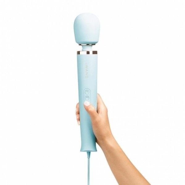 Hand holding a light blue handheld device on a white background