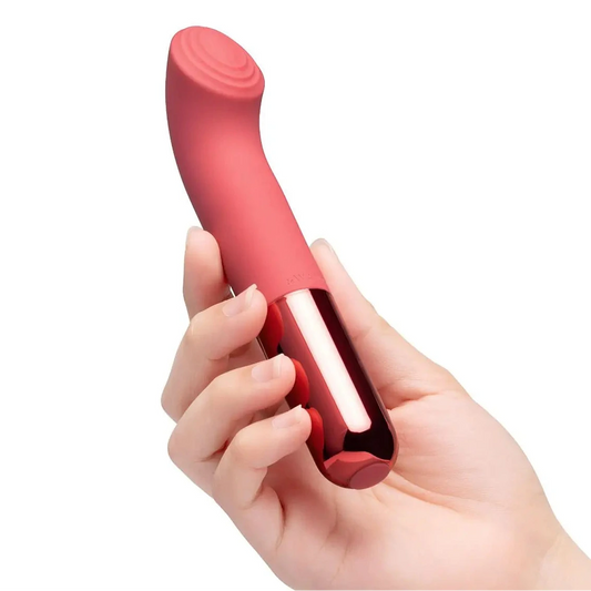 Red handheld G-spot massage device held in a hand against a white background