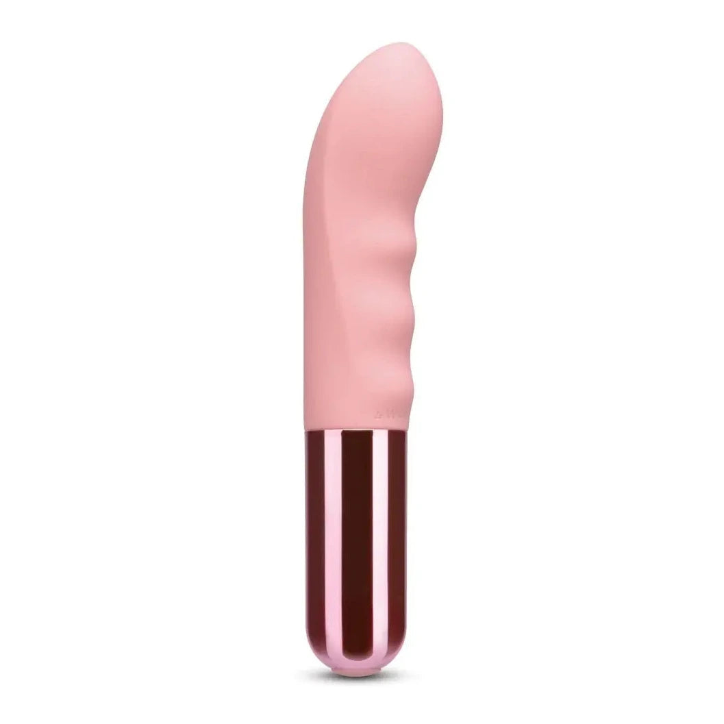 Pink and red cylindrical g-spot massager on a white background