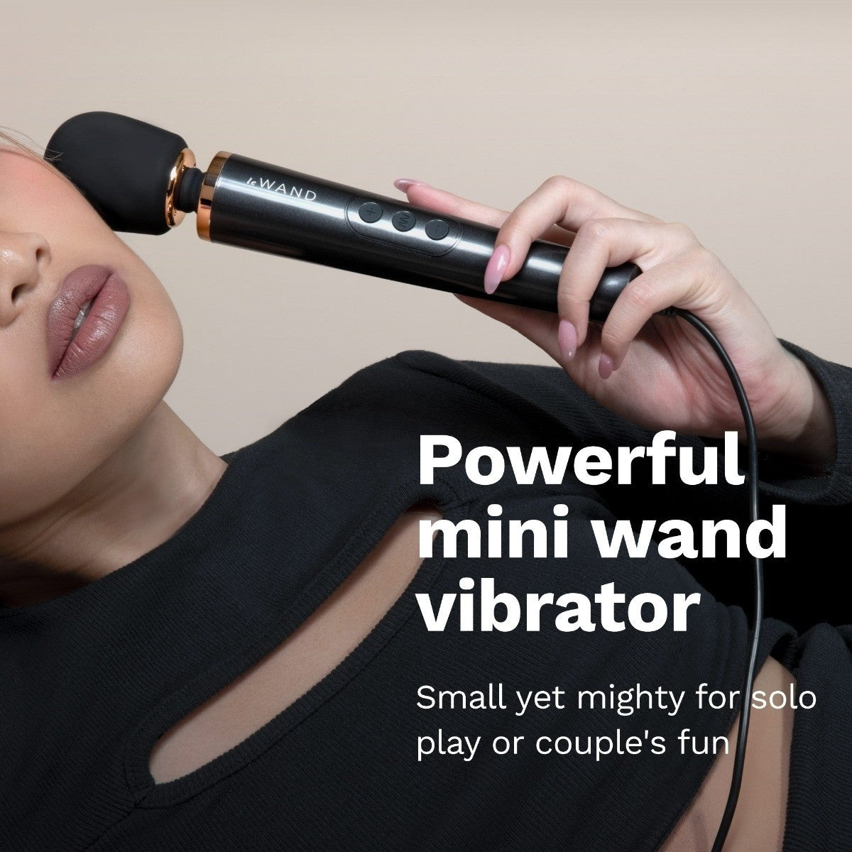 Person using a black mini wand vibrator with text describing its features.