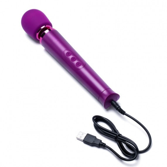 Purple handheld device with a USB cable on a white background