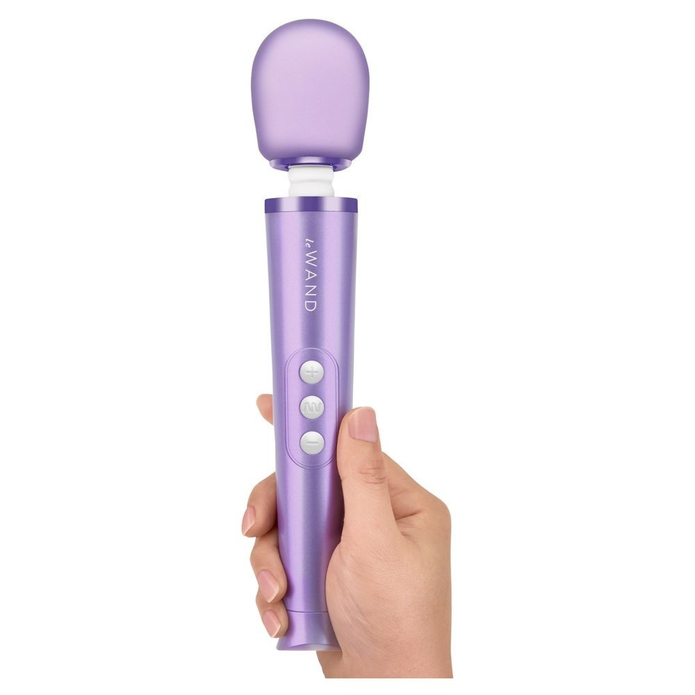Purple handheld electronic device held in a hand on a white background
