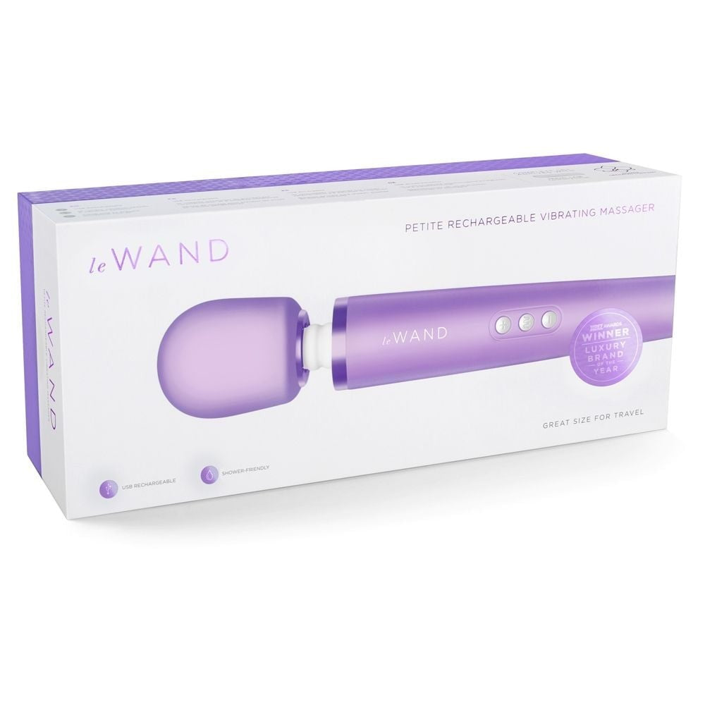 Purple 'Le Wand' petite rechargeable vibrating massager in packaging on a white background