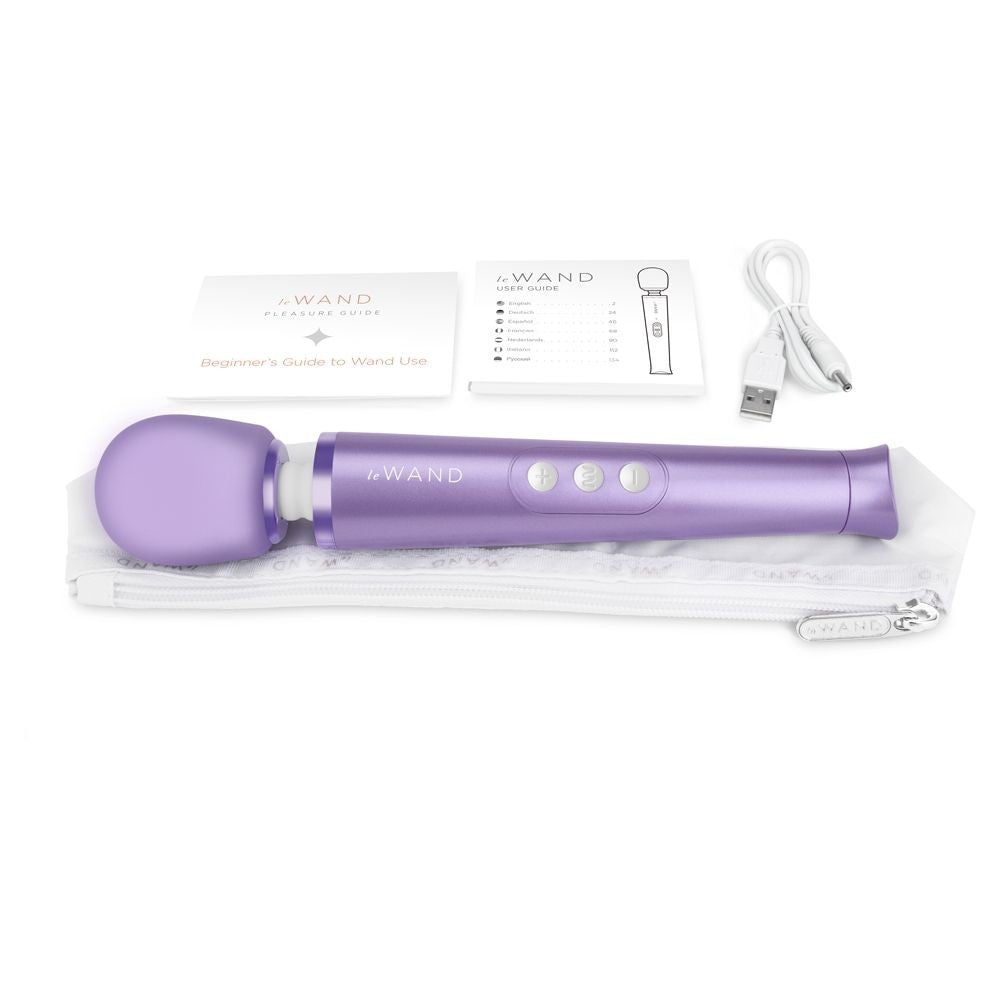 Purple handheld vibrator with packaging on a white background