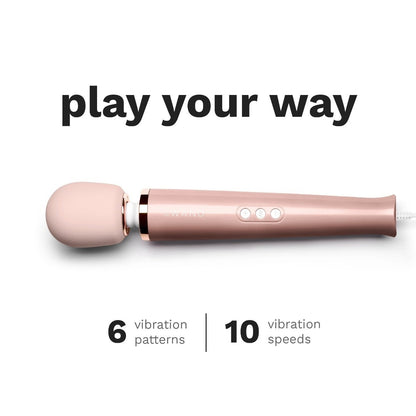 Rose gold handheld massager with text on a white background