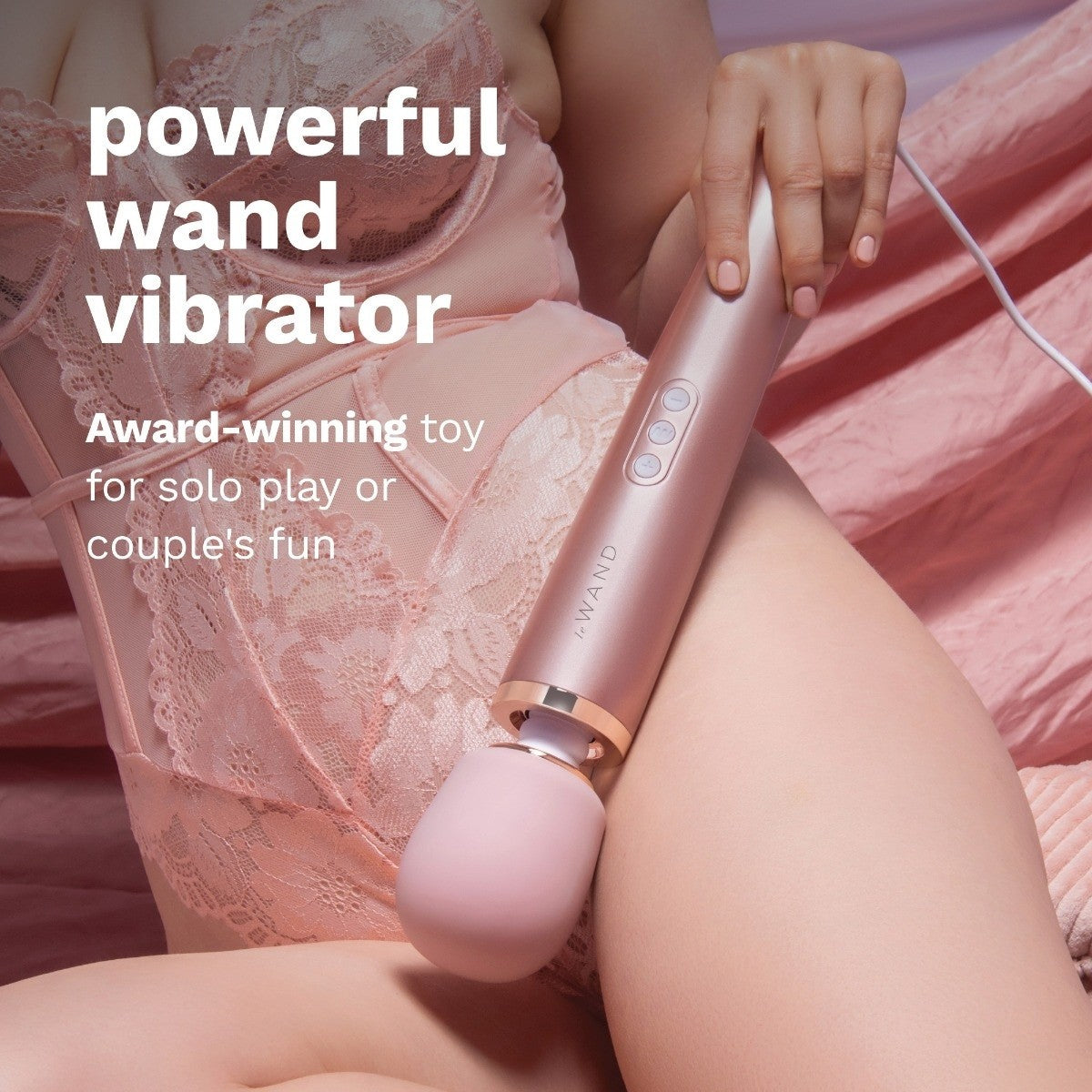 Rose gold wand vibrator held by a person in a pink lace garment with text about its use.