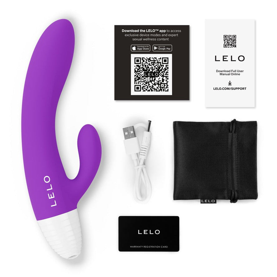 Purple and white Lelo massage rabbit vibrator device with accessories on a white background