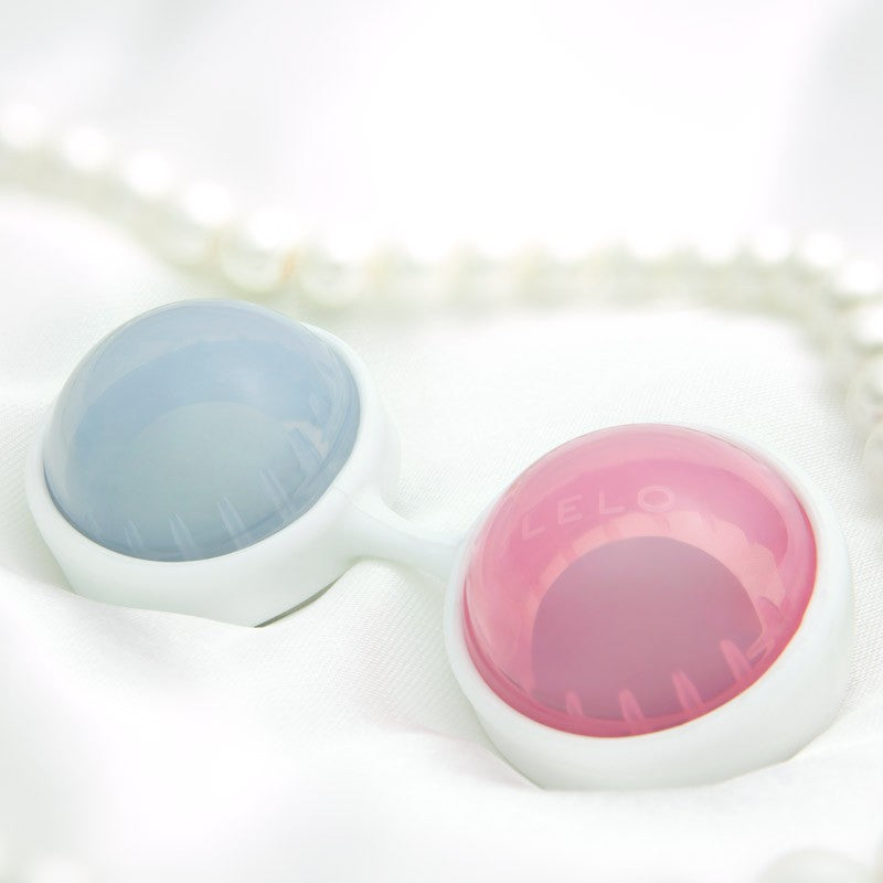 kegel exerciser with blue and pink balls on a white background
