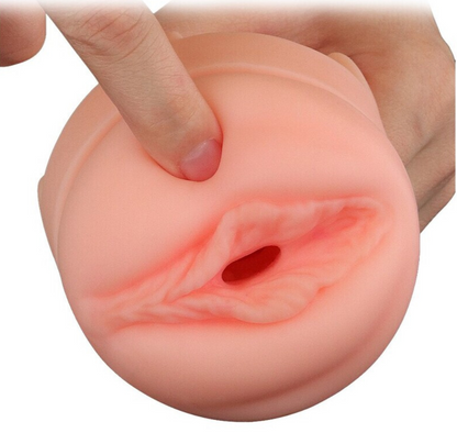 Realistic silicone model of a female reproductive organ with a finger pressing on it, on a white background.