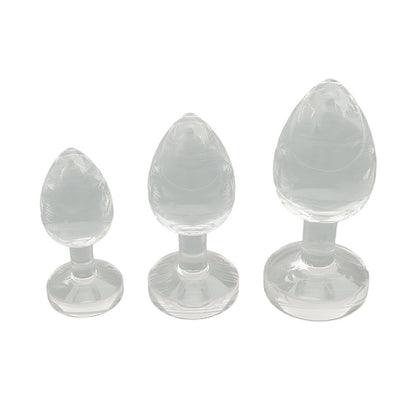 Three clear silicone butt plugs of different sizes on a white background