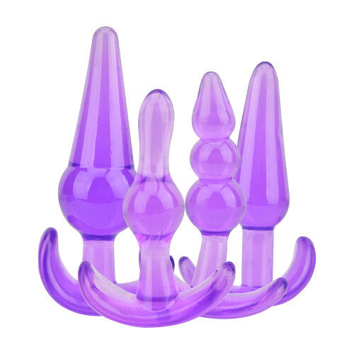 Set of purple silicone butt plugs on a white background