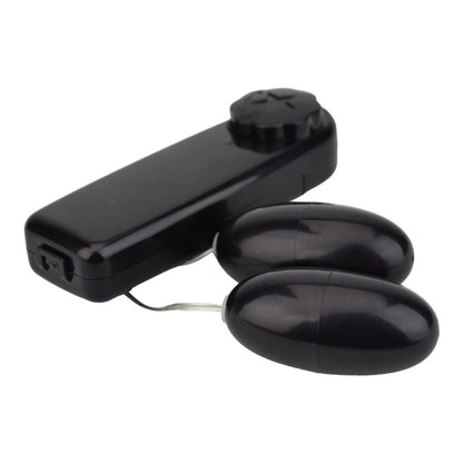 Black electronic device with two oval attachments on a white background