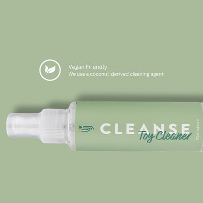 Green bottle of 'CLEANSE Toy Cleaner' with a coconut-derived cleaning agent label on a green background