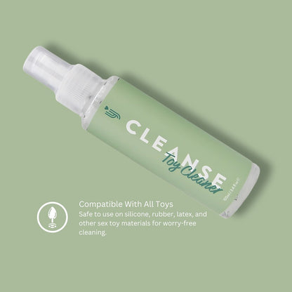 Green bottle of 'CLEANSE Toy Cleaner' on a light green background