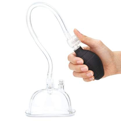 Hand holding a black and clear vacuum pump on a white background