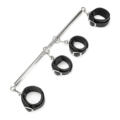 Black bondage cuffs with a metal rod on a white background