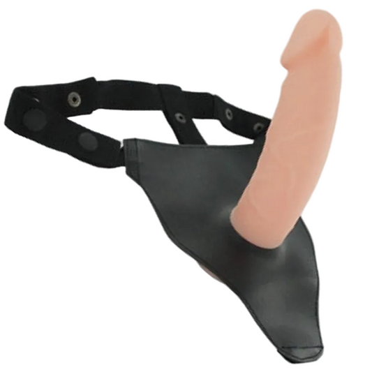 Black leather harness with a pink silicone penis dildo on a white background