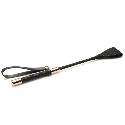 Black and gold horsewhip on a white background