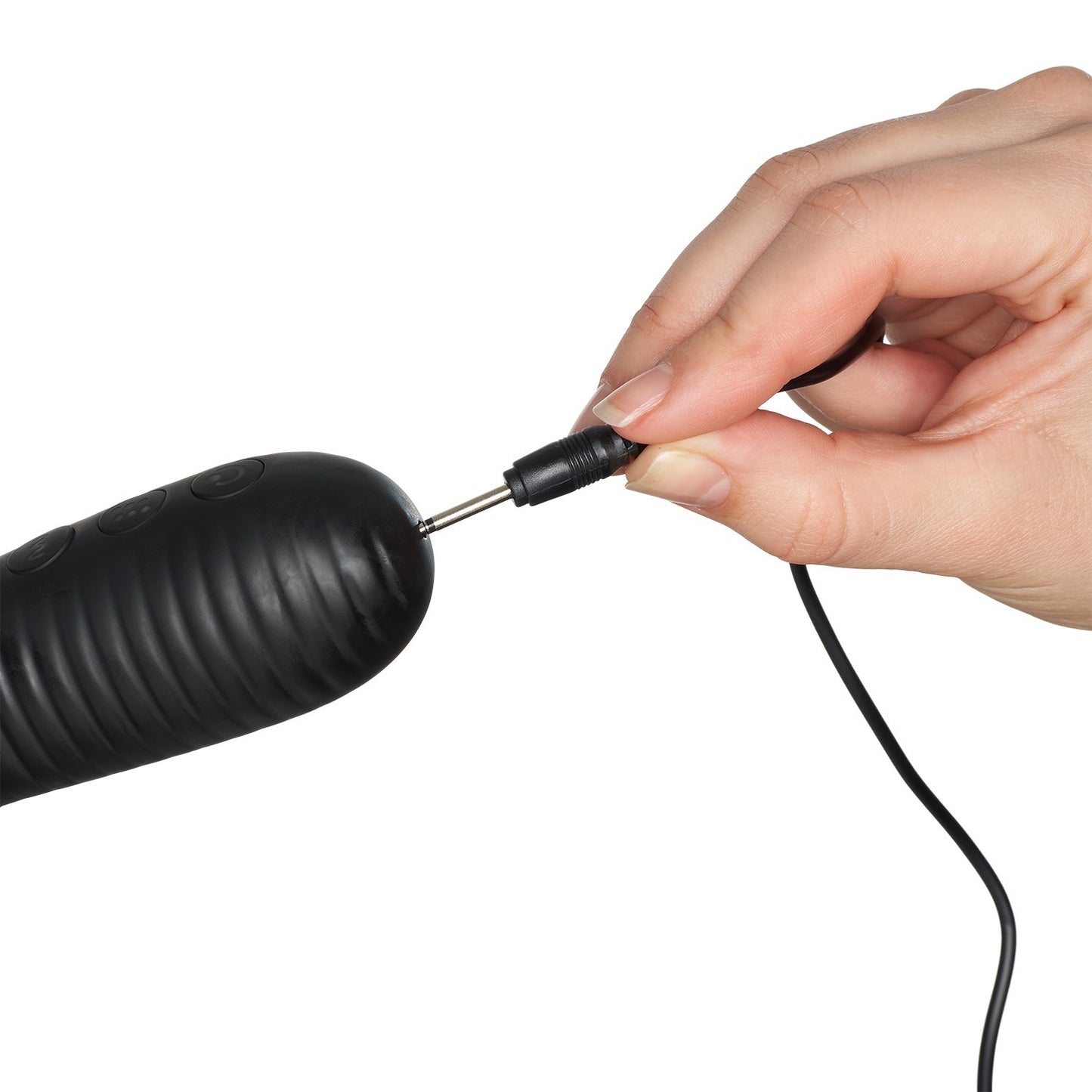 Hand holding a black electronic device with a cable against a white background