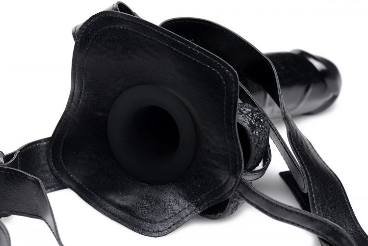 Black leather harness with a strap on a white background