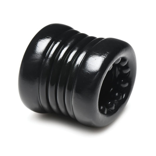 Black ribbed cylindrical testicle ring on a white background