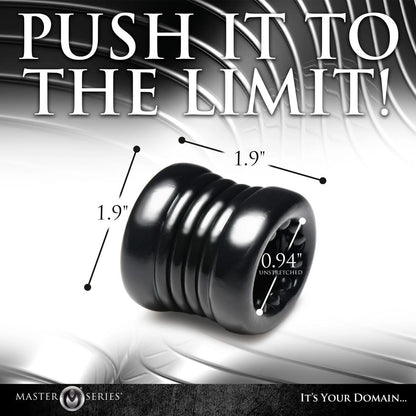 Black rubber testicle ring with measurements and 'Push It to the Limit!' text on a reflective surface.