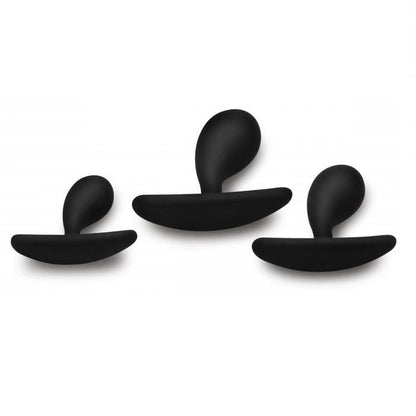 Three black anal plugs on a white background