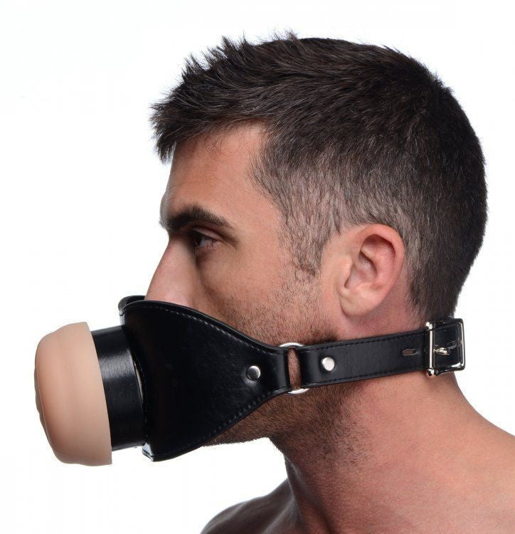 Man wearing a black leather muzzle with a white background